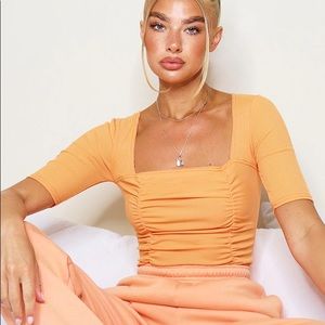 Pastel Orange Ruched Short Sleeve Bodysuit